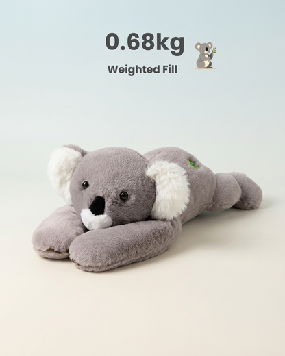 A plush koala toy lying on its stomach, shown against a clean light background with text reading '0.68kg Weighted Fill' and a small koala icon.